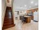 Bright kitchen features a central island with bar seating and stainless steel appliances at 10785 Corsican St # 3, Orlando, FL 32824