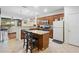 Spacious kitchen featuring stainless appliances, granite countertops, island, and adjacent living area at 10785 Corsican St # 3, Orlando, FL 32824