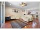 An open-concept living room with a white sectional sofa, a leopard rug, and an open view to the kitchen at 10785 Corsican St # 3, Orlando, FL 32824