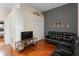 Cozy living room with hardwood floors, black leather sofa and gaming decor at 10785 Corsican St # 3, Orlando, FL 32824
