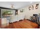 A cozy living room with a white leather sectional sofa, dark wood floors, and sliding glass doors to the outdoor patio at 10785 Corsican St # 3, Orlando, FL 32824