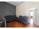Comfortable living room with dark-colored leather furniture, wood floors, and plenty of room to relax at 10785 Corsican St # 3, Orlando, FL 32824