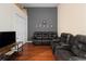 Comfortable living room featuring a black leather reclining sofa at 10785 Corsican St # 3, Orlando, FL 32824