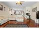 Open-concept living room with a white sectional sofa, open view to the kitchen, and wood flooring at 10785 Corsican St # 3, Orlando, FL 32824