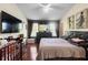Spacious main bedroom featuring a ceiling fan, large window and en-suite bathroom at 10785 Corsican St # 3, Orlando, FL 32824