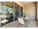 Inviting outdoor patio with table and chairs, screened-in porch, and a view into the living area at 10785 Corsican St # 3, Orlando, FL 32824