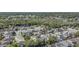 An aerial view of a neighborhood, showcasing the homes, landscaping, and nearby lake at 122 Carmel Bay Dr, Sanford, FL 32771