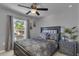 Serene bedroom with ceiling fan, natural light, neutral tones, and stylish decor at 122 Carmel Bay Dr, Sanford, FL 32771