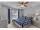 Stylish bedroom featuring a decorative ceiling fan, large window, and modern furniture at 122 Carmel Bay Dr, Sanford, FL 32771