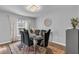 Elegant dining room with modern chandelier, stylish table setting, and ample natural light at 122 Carmel Bay Dr, Sanford, FL 32771