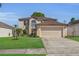 Two-story home with a two car garage and lush green lawn at 122 Carmel Bay Dr, Sanford, FL 32771