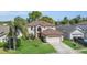 Exterior view of a two-story home with a two-car garage and mature landscaping at 122 Carmel Bay Dr, Sanford, FL 32771