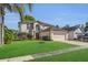 Two-story home with a two-car garage, landscaped yard, and a well-kept lawn at 122 Carmel Bay Dr, Sanford, FL 32771