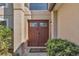 Inviting front door with decorative glass panels and elegant exterior lighting at 122 Carmel Bay Dr, Sanford, FL 32771