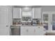 Functional kitchen with white cabinetry, granite counters, and stainless steel dishwasher at 122 Carmel Bay Dr, Sanford, FL 32771