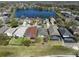 An aerial view of homes backing to a scenic lake, showcasing the desirable neighborhood and tranquil setting at 13850 Mirror Lake Dr, Orlando, FL 32828