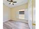 Cozy bedroom with a ceiling fan, hardwood floors, open window with shutters, and a closet at 13850 Mirror Lake Dr, Orlando, FL 32828