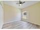 Light and airy bedroom featuring wood floors, neutral paint, and a window with plantation shutters at 13850 Mirror Lake Dr, Orlando, FL 32828