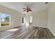 Bedroom with laminate flooring, fan, and natural light from two windows at 13850 Mirror Lake Dr, Orlando, FL 32828