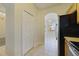 Hallway with tile flooring and a view into the dining nook with ample natural light from exterior windows at 13850 Mirror Lake Dr, Orlando, FL 32828