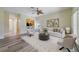 Bright living room featuring modern neutral décor, an eye catching ceiling fan, and a view of the kitchen at 13850 Mirror Lake Dr, Orlando, FL 32828