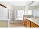 A bright main bathroom with a tiled shower, separate tub, and a stylish vanity with built in storage at 13850 Mirror Lake Dr, Orlando, FL 32828