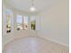 Bright room with tile floor, multiple windows, and white shutters at 13850 Mirror Lake Dr, Orlando, FL 32828