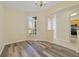 Well-lit room with laminate flooring and a large window at 13850 Mirror Lake Dr, Orlando, FL 32828