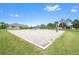 Outdoor sand volleyball court on a sunny day, surrounded by green grass at 13850 Mirror Lake Dr, Orlando, FL 32828