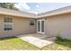 Backyard patio with double doors, sunny area, exterior siding, and green grass at 1456 Providence Blvd, Deltona, FL 32725