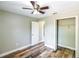 Inviting bedroom with wood-look floors, ceiling fan, closet, and a bright interior at 1456 Providence Blvd, Deltona, FL 32725