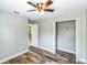 Comfortable bedroom with wood-look floors, ceiling fan, and closet with white doors at 1456 Providence Blvd, Deltona, FL 32725