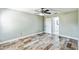 Relaxing bedroom with wood-look tile flooring, and an en suite bathroom at 1456 Providence Blvd, Deltona, FL 32725