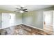 Bedroom with wood-look tile, en suite, natural light and ceiling fan at 1456 Providence Blvd, Deltona, FL 32725