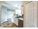 Updated kitchen featuring white cabinets, a stainless steel dishwasher, and a view into the living room at 1456 Providence Blvd, Deltona, FL 32725