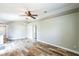 Open living room with wood-look floors, ceiling fan, neutral paint and natural light at 1456 Providence Blvd, Deltona, FL 32725