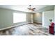 Inviting living room with wood-look tile flooring, a large window, and modern lighting fixtures at 1456 Providence Blvd, Deltona, FL 32725