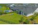 Aerial view of the home with a lush backyard, a pool, a covered patio, and an iron fence at 14691 Walcott Ave, Orlando, FL 32827