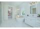 Elegant bathroom featuring a soaking tub, double vanity, and access to a luxurious closet at 14691 Walcott Ave, Orlando, FL 32827