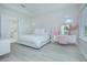 Bright bedroom features a bed, white floors, and a vanity at 14691 Walcott Ave, Orlando, FL 32827