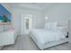 Light, airy bedroom boasts white walls, floors, a comfortable bed and TV at 14691 Walcott Ave, Orlando, FL 32827