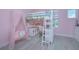 Pink bedroom with a loft bed, a vanity, and light wood flooring at 14691 Walcott Ave, Orlando, FL 32827