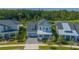 Exterior view of the home with a well-manicured lawn, driveway, and a mix of light and dark colors at 14691 Walcott Ave, Orlando, FL 32827