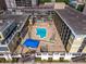 Capture the allure of a building with its rooftop pool, lounge, and cityscape vistas in this aerial perspective at 151 E Washington St # 419, Orlando, FL 32801