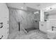 Modern bathroom with marble walls, glass shower, and sleek fixtures at 151 E Washington St # 419, Orlando, FL 32801