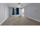 Bright bedroom featuring neutral carpeting, balcony access, and a ceiling fan at 151 E Washington St # 419, Orlando, FL 32801