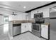 Modern kitchen featuring stainless steel appliances, white cabinetry, and a breakfast bar area at 151 E Washington St # 419, Orlando, FL 32801