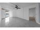 Bright living room with a ceiling fan and balcony access, enhanced by modern tile flooring at 151 E Washington St # 419, Orlando, FL 32801