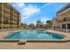 Bright swimming pool surrounded by condos with plenty of lounge chairs for residents to enjoy under the sunny sky at 151 E Washington St # 419, Orlando, FL 32801