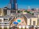 An aerial shot reveals a luxurious rooftop pool, lounge area, and stunning city views at 151 E Washington St # 419, Orlando, FL 32801